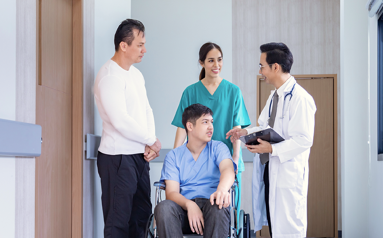 Nurse and doctor with a boy with Duchenne and his father