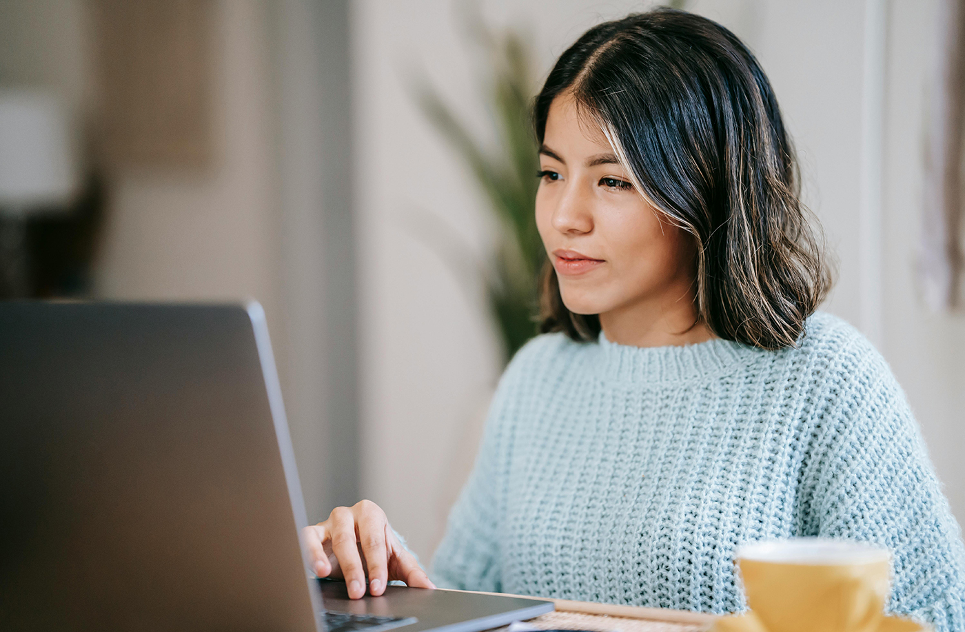 Woman filling out a form in her laptop