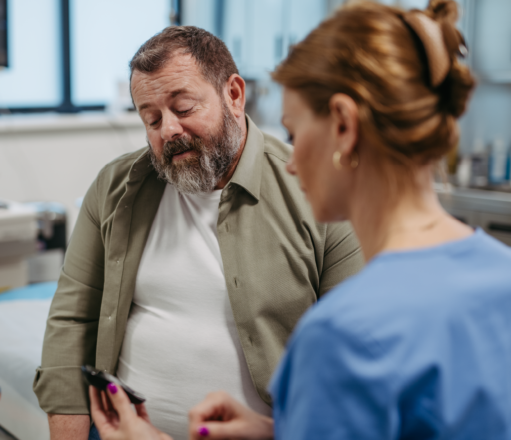 Doctor checking blood glucose level using a fingerstick glucose meter, waiting for results