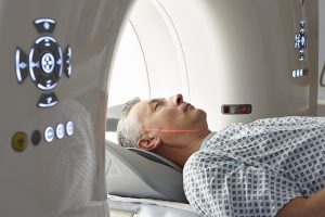 A man lying inside an MRI scanner while undergoing a brain scan.