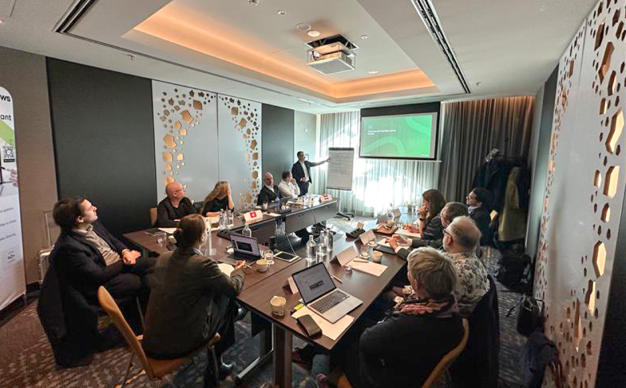 Photo of the myTomorrows European Advisory Board meeting, including all participants listening to a presentation