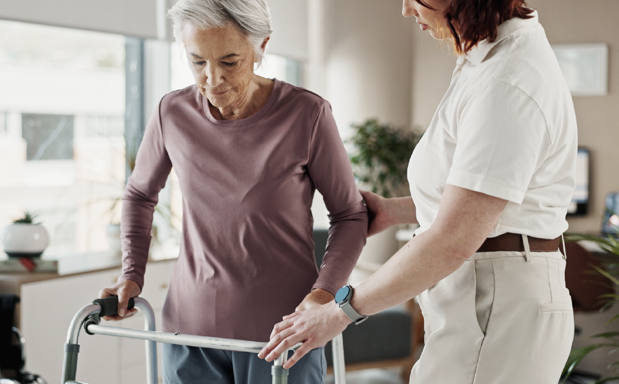Older woman walking with the help of a walker