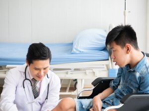 Doctor examining a boy with Duchenne