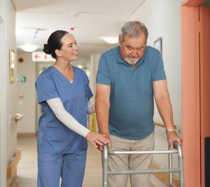 Person with advanced ALS with trouble moving, using a walker