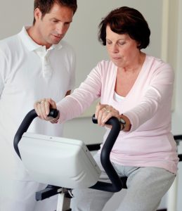 Woman with ALS using stationary bike