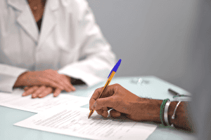 Patient signing an informed consent